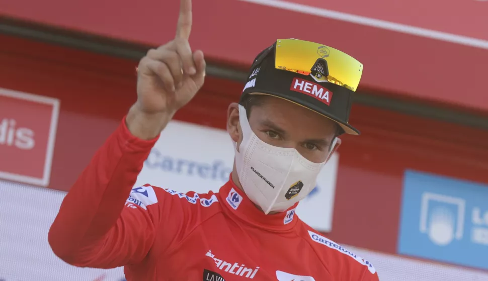 epa09420693 The overall leader, Slovenian Primo Roglic of Jumbo team, wearing the red maillot jersey, celebrates on the podium after the 6th stage of the Spanish Cycling Vuelta, a 158.3km-long race between Requena and Montana de Cullera, Spain, 19 August 2021. EPA/Manuel Bruque