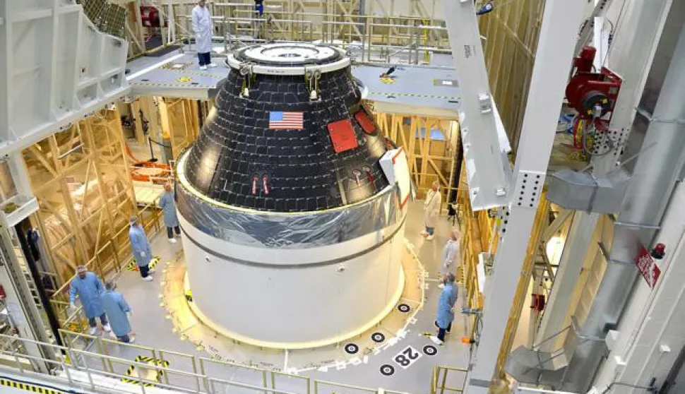 epa04391151 A handout picture dated 07 September 2014 and made available by NASA on 08 September 2014 shows NASAs first completed Orion crew module, sitting atop its service module at the Neal Armstrong Operations and Checkout Facility at Kennedy Space Center in Florida. The crew and service module will be transferred together on 10 September 2014 to another facility for fueling, before moving again for the installation of the launch abort system. At that point, the spacecraft will be complete and ready to stack on top of the Delta IV Heavy rocket that will carry it into space on its first flight in December. For that flight, Exploration Flight Test-1, Orion will travel 3,600 miles above the Earth farther than any spacecraft built to carry people has traveled in more than 40 years and return home at speeds of 20,000 miles per hour, while enduring temperatures near 4,000 degrees Fahrenheit. EPA/RAD SINYAK/HANDOUT HANDOUT EDITORIAL USE ONLY