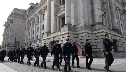 epa07061231 A group of policemen walk past the Reichstag in Berlin, Germany, 01 October 2018. According to reports, six men were arrested on 01 October 2018 as per order of Germany's attorney general. The six men are charged with forming a far-right terror group known as 'Revolution Chemnitz.' The group is suspected of trying to purchase weapons in order to perform attacks on 2018's Day of German Unity festivities. EPA/FELIPE TRUEBA