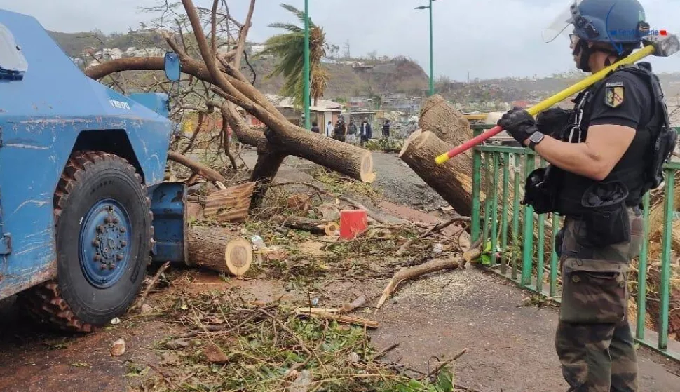 epa11782347 A handout photo made available by the Mayotte Gendarmerie on 17 December 2024 shows a French Gendarme clearing a fallen tree out of the way in the French overseas territory of Mayotte, 17 December 2024. Several hundred people may have been killed after tropical cyclone Chido battered the French Indian Ocean territory of Mayotte on 14 December, authorities said. EPA/HANDOUT BEST QUALITY AVAILABLEHANDOUT EDITORIAL USE ONLY/NO SALES
