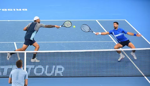 epaselect epa11800784 Novak Djokovic (R) of Serbia and Nick Kyrgios (L) of Australia in action during their doubles match against Nikola Mektic and Michael Venus of New Zealand at the Brisbane International tennis tournament in Queensland Tennis Centre in Brisbane, Australia, 01 January 2025.  EPA/JONO SEARLE AUSTRALIA AND NEW ZEALAND OUT