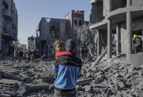 epa11803411 A Palestinian father carries his daughter next to the destroyed house of the Abu Libda family following an Israeli air strike in Al Maghazi refugee camp, central Gaza Strip, 03 January 2025. According to reports from the Ministry of Health in Gaza at least nine members of the Abu Libda family were killed following an Israeli air strike in the refugee camp. More than 45,500 Palestinians and over 1,400 Israelis have been killed, according to the Palestinian Health Ministry and the Israeli Army, since Hamas militants launched an attack against Israel from the Gaza Strip on 07 October 2023 and the Israeli operations in Gaza and the West Bank that followed it. EPA/MOHAMMED SABER
