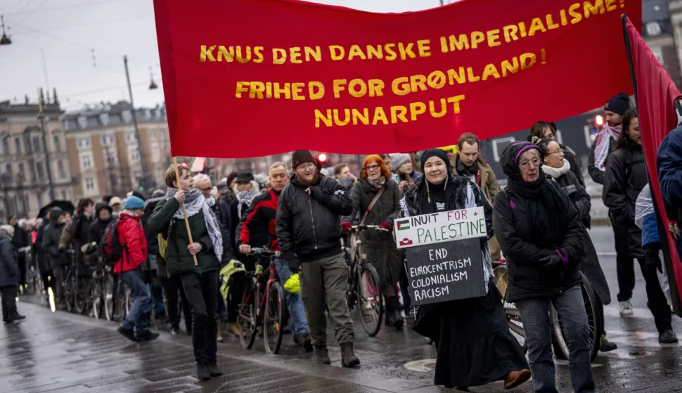 epa11855365 People participate in a protest against American presence in Denmark, during a march in Copenhagen, Denmark, 26 January 2025. US President Donald Trump told members of the media on board the Air Force One plane on 26 January 2025 that he expects Greenland to reach an arrangement with the USA. The banner reads 'Crush Danish imperialism! Freedom for Greenland!' EPA/IDA MARIE ODGAARD DENMARK OUT