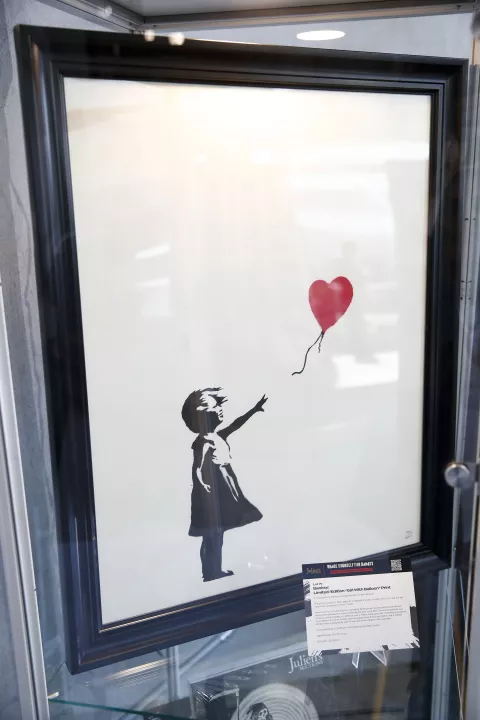 epa10546123 A limited-edition Banksy screenprint titled 'Girl With Balloon' is displayed during an auction preview titled 'Brace Yourself for Banksy: Modern and Contemporary Art' at Julien's Auctions Beverly Hills in Beverly Hills, California, USA, 27 March 2023. EPA/CAROLINE BREHMAN