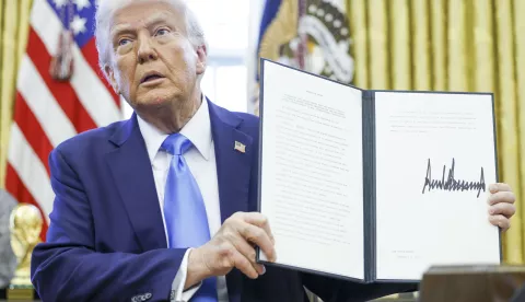 epa11875453 US President Donald Trump holds up a newly signed executive order withdrawing the United States from the United Nations Human Rights Council in the Oval Office of the White House in Washington, DC, USA, 04 February 2025. EPA/SHAWN THEW/POOL