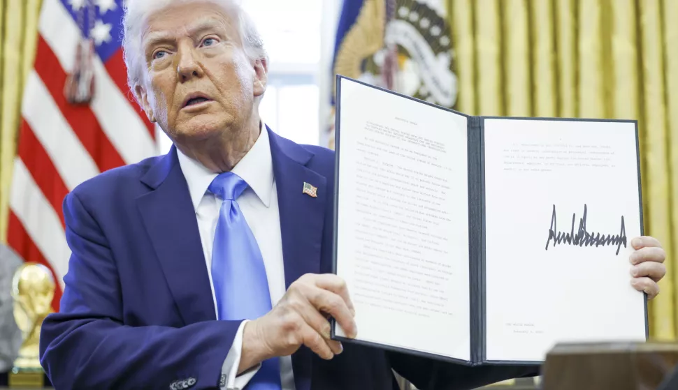 epa11875453 US President Donald Trump holds up a newly signed executive order withdrawing the United States from the United Nations Human Rights Council in the Oval Office of the White House in Washington, DC, USA, 04 February 2025. EPA/SHAWN THEW/POOL