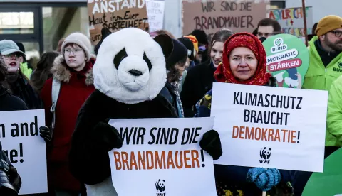 epa11872464 Protesters hold signs reading 'We are the firewall' (C) and 'Climate Protection need democracy' (R) during a protest against cooperation with the Alternative for Germany 'AfD' party ahead of the Christian Democratic Union 'CDU' federal party conference in Berlin, Germany, 03 February 2025. People gathered to protest against the CDU's cooperation with the AfD party after the CDU's motion in the Bundestag won a majority with the help of AfD votes. EPA/Filip Singer