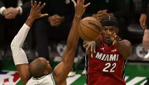 epa10635490 Miami Heat forward Jimmy Butler (R) passes the ball in front of Boston Celtics center Al Horford (L) during the third quarter of game one of the NBA Eastern Conference finals series between the Miami Heat and the Boston Celtics at TD Garden in Boston, Massachusetts, USA, 17 May 2023. EPA/JOHN CETRINO SHUTTERSTOCK OUT