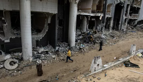 epa11876284 People walk near the damaged Al-Shifa hospital, amid a ceasefire between Israel and Hamas, in Gaza City, Gaza Strip, 05 February 2025. Israel and Hamas implemented the first phase of a hostage release and ceasefire deal on 19 January 2025. More than 46,000 Palestinians have been killed in the Gaza Strip, according to the Palestinian Ministry of Health, since Israel launched a military campaign in the strip in response to a cross-border attack led by the Palestinian militant group Hamas on 07 October 2023, in which about 1,200 Israelis were killed and more than 250 taken hostage. EPA/HAITHAM IMAD