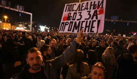 epa11857221 A protester holds a banner reading 'Last train for changes' during the blockade of the 'Autokomanda' intersection in Belgrade, Serbia, 27 January 2025. University students staged a protest, demanding accountability after fifteen people lost their lives in the collapse of the Novi Sad Railway Station canopy on 01 November 2024. EPA/ANDREJ CUKIC