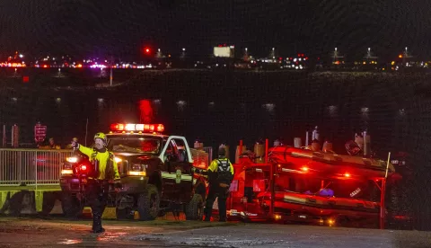 epa11862691 Rescue teams stage to help search the Potomac River after a commercial airplane reportedly collided with a military helicopter on approach to Ronald Reagan National Airport in Washington, DC, USA, 29 January 2025. According to a preliminary statement from the United States Federal Aviation Administration (FAA), a PSA Airlines Bombardier CRJ700 regional jet that departed earlier today from Wichita, Kansas collided in midair with a Sikorsky H-60 helicopter while on approach to Reagan Washington National Airport. EPA/SHAWN THEW