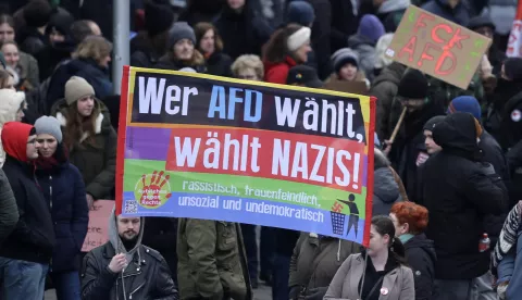 epa11878999 Protesters hold a banner reading 'Whoever votes for AFD votes for Nazis' during a Christian Democratic Union (CDU) party election campaign event with chancellor candidate Merz in Sankt Ingbert, Germany, 06 February 2025. Germany will hold early federal elections on 23 February 2025. EPA/RONALD WITTEK