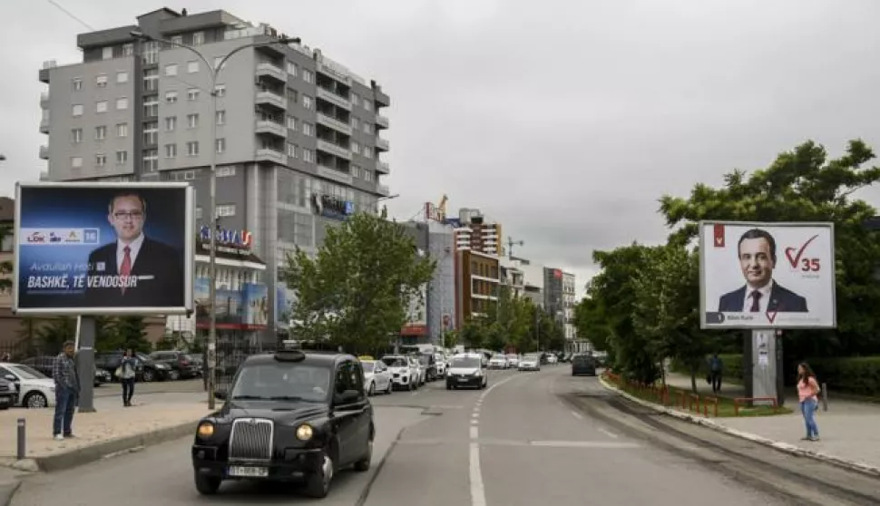 epa06017083 Traffic rolls between election posters for the parliamentary elections showing the Prime Minister candidates, the leader of the Democratic League of Kosovo (LDK) Avdullah Hoti (L) and the leader of the opposition party Selfdetermination (Vetvendosje), Albin Kurti (R), in Pristina, Kosovo, 08 June 2017. Kosovo's early elections will be held on 11 June 2017. EPA/PETRIT PRENAJ