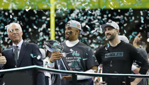 epa11885579 Philadelphia Eagles quarterback Jalen Hurts holds the Vince Lombardi Super Bowl LIX trophy next to head coach Nick Sirianni (R) and owner Jeffrey Lurie on after winning Super Bowl LIX against the Kansas City Chiefs at Caesars Superdome in New Orleans, Louisiana, USA, 09 February 2025. The Super Bowl is the annual championship game of the NFL between the AFC Champion and the NFC Champion and has been held every year since 1967. EPA/ERIK S. LESSER