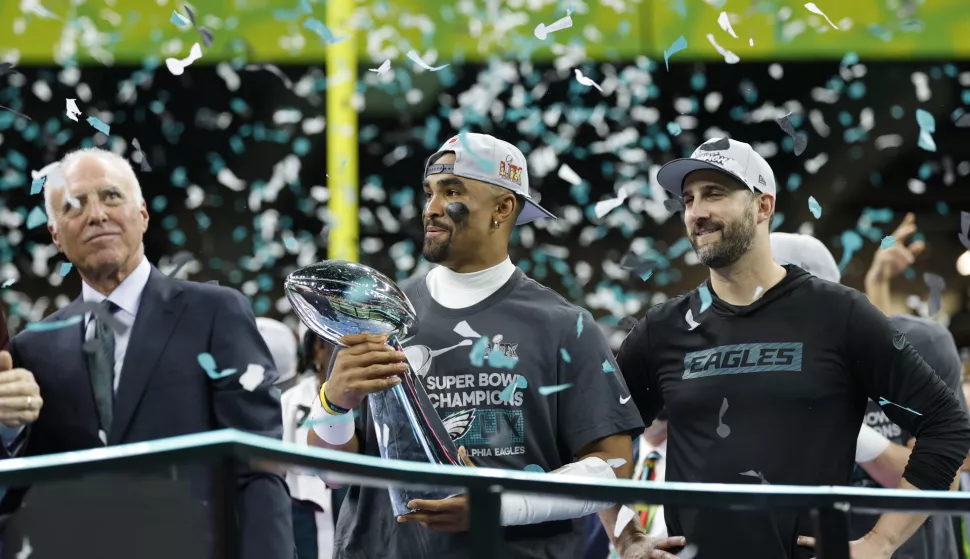 epa11885579 Philadelphia Eagles quarterback Jalen Hurts holds the Vince Lombardi Super Bowl LIX trophy next to head coach Nick Sirianni (R) and owner Jeffrey Lurie on after winning Super Bowl LIX against the Kansas City Chiefs at Caesars Superdome in New Orleans, Louisiana, USA, 09 February 2025. The Super Bowl is the annual championship game of the NFL between the AFC Champion and the NFC Champion and has been held every year since 1967. EPA/ERIK S. LESSER