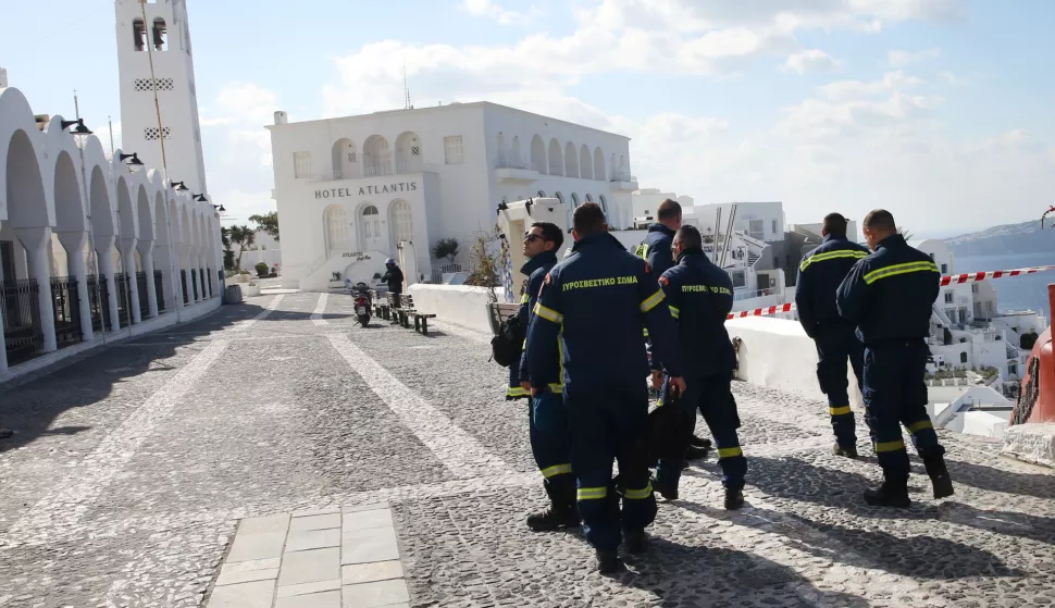 epa11878645 Firefighters walk in the almost evacuated village of Fira in Santorini, Greece, 06 February 2025. The municipality of Thera (Santorini) advised the emptying of water from swimming pools, banned all construction work and forbade access to the Athinio port, except when ships are docking, due to a wave of seismic activity. More than ten earthquakes of over 4.0 magnitude have jolted the region since the night of February 4. EPA/ORESTIS PANAGIOTOU