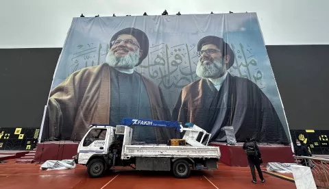 epa11914827 Workers hang a banner featuring the portraits of late Hezbollah leaders Hassan Nasrallah (L) and Hashem Safieddine, ahead of their funeral ceremony at Beirut Sports City in Beirut, Lebanon, 22 February 2025. The funeral of Nasrallah and Safieddine will be held at the Beirut Sports City on 23 February, about five months after they were killed in separate Israeli strikes. EPA/WAEL HAMZEH