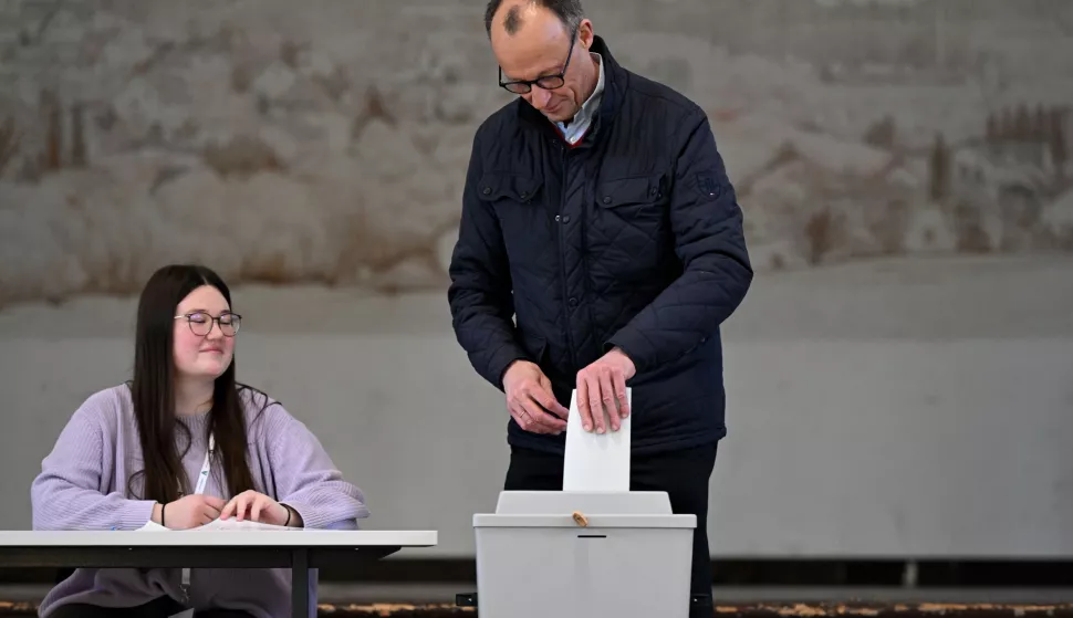 epa11917765 Chairman of the Christian Democratic Union (CDU) party and chancellor candidate Friedrich Merz (R) casts his vote for the general election, at a polling station in Arnsberg, Germany, 23 February 2025. About 60 million people are eligible to vote in the German elections for a new federal parliament, the 21st Bundestag. EPA/FABIAN STRAUCH