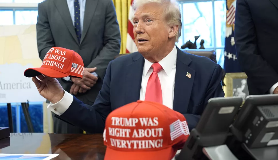 epa11924637 US President Donald Trump holds a hat reading 'Trump was right about everything' after signing executive orders in the Oval Office of the White House in Washington, DC, USA, 25 February 2025. EPA/YURI GRIPAS/POOL