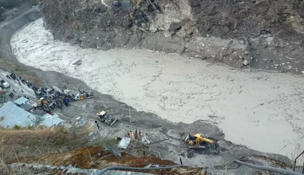 epa08993669 A general view of a rescue operation near the Dhauliganga hydro power project after a portion of Nanda Devi glacier broke off, at Reni village in Chamoli district, Uttrakhand, India, 07 February 2021. Over 100 people are feared dead after part of the Nanda Devi glacier broke off causing massive floods in the Tapovan area of Uttarakhand's Chamoli district. EPA/ARVIND MOUDGIL -- BEST QUALITY AVAILABLE --