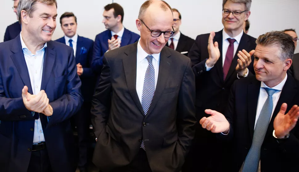 epa11923727 Chairman of the Christian Democratic Union (CDU) party and faction, Friedrich Merz (C), receives applause from Bavarian State Premier and Christian Social Union (CSU) chairman, Markus Soeder (L), and Christian Democratic Union (CDU) and Christian Social Union (CSU) faction parliamentary manager in the German parliament Bundestag, Thorsten Frei (R), during a parliamentary group meeting at the Bundestag in Berlin, Germany, 25 February 2025. Germany held early federal elections on 23 February. EPA/CLEMENS BILAN
