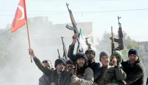 epa06454810 Members of Free Syrian Army (Turkey-backed) fighters tour with their guns as they hold Turkish and their flag in the Syria city of Azez, near the Syrian-Turkish border, 19 January 2018. Report state that the Turkish army is preparing for an operation in Syria against the Kurdish Popular Protection Units (YPG) forces. EPA/HASAN KIRMIZITAS