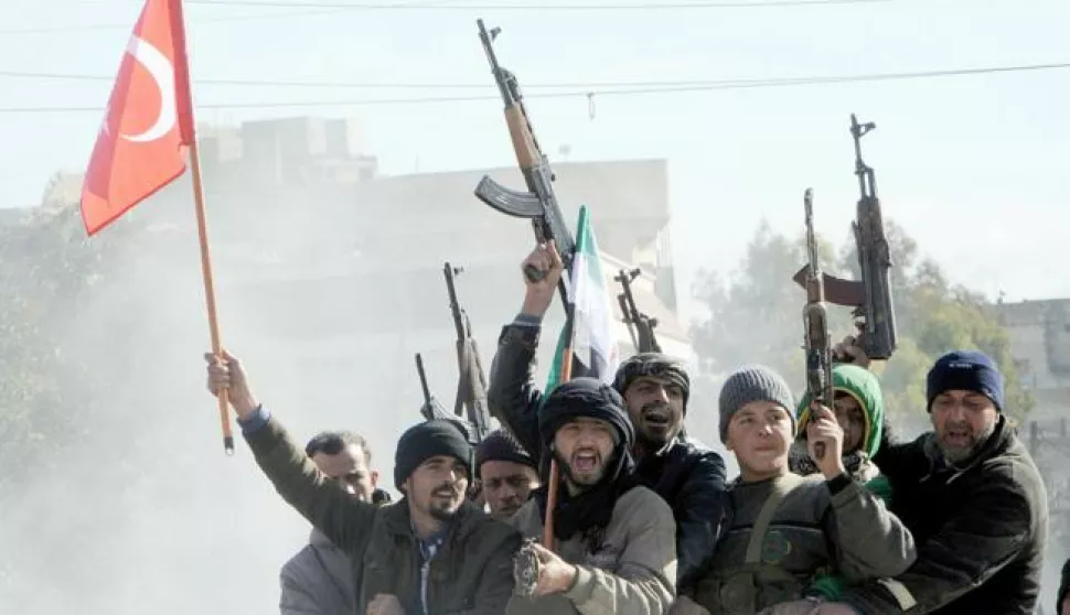 epa06454810 Members of Free Syrian Army (Turkey-backed) fighters tour with their guns as they hold Turkish and their flag in the Syria city of Azez, near the Syrian-Turkish border, 19 January 2018. Report state that the Turkish army is preparing for an operation in Syria against the Kurdish Popular Protection Units (YPG) forces. EPA/HASAN KIRMIZITAS