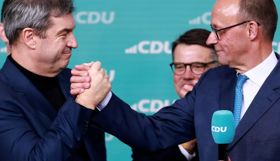 epa11919476 Chairman of Germany's Christian Democratic Union (CDU) Friedrich Merz (R) and State Premier of Bavaria and Christian Social Union (CSU) chairman Markus Soeder (L) celebrate during the Christian Democratic Union (CDU) election event in Berlin, Germany, 23 February 2025. EPA/HANNIBAL HANSCHKE