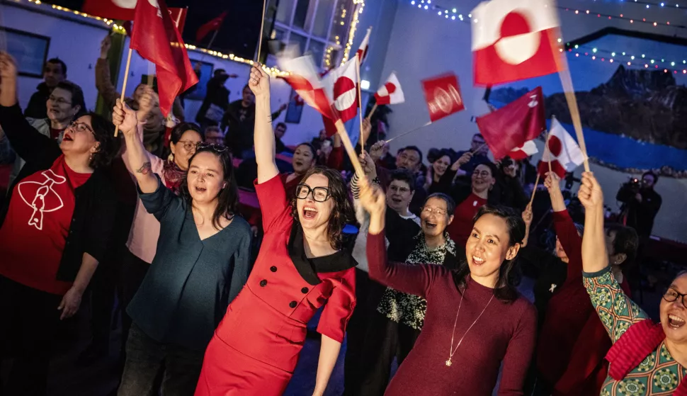 epa11957706 People wave flags during the Inuit Ataqatigiit (IA) party's election party at the Assembly House, in Nuuk, Greenland, 11 March 2025 (issued 12 March 2025). Greenland residents on 11 March voted to elect 31 members to the Inatsisartut, the Greenlandic parliament, with Demokraatit party emerging as the leading party in Greenland's elections with 29.9 percent of the votes. EPA/MADS CLAUS RASMUSSEN DENMARK OUT