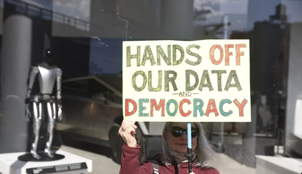 epa11933290 People gather to protest Tesla CEO Elon Musk's involvement with the Trump administration, outside the Tesla Meatpacking District showroom in New York, USA, 01 March 2025. Musk has been put in charge of the Department of Government Efficiency (DOGE), making cuts to government jobs. EPA/SARAH YENESEL