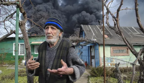 epa11955575 A man reacts as smoke billows above the site of a drone attack in Odesa, southern Ukraine, 11 March 2025, amid the ongoing Russian invasion. A Russian drone attack late on 10 March damaged fuel tanks, a residential building, and a warehouse according to Ukraine's State Emergency Services with no deaths or injuries reported. EPA/IGOR TKACHENKO