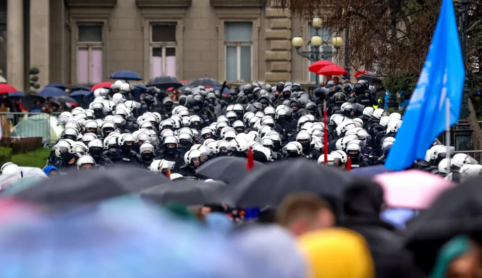 epa11966396 Protesters walk in front of the riot police during the student-led rally in Belgrade, Serbia, 15 March 2025. University students staged a protest, demanding accountability after fifteen people lost their lives in the collapse of the Novi Sad Railway Station canopy in November 2024. The station building, which had been renovated and reopened in July 2024, was undergoing further renovations shortly before the collapse. EPA/ANDREJ CUKIC