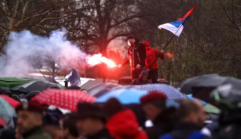 epa11966395 A protester holds a flare during the student-led rally in Belgrade, Serbia, 15 March 2025. University students staged a protest, demanding accountability after fifteen people lost their lives in the collapse of the Novi Sad Railway Station canopy in November 2024. The station building, which had been renovated and reopened in July 2024, was undergoing further renovations shortly before the collapse. EPA/ANDREJ CUKIC