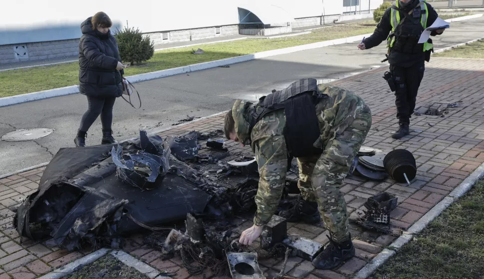 epaselect epa11971464 Ukrainian experts inspect the debris of a Russian drone that fell in the morning near a school on the outskirts of Kyiv, Ukraine, 18 March 2025, amid the ongoing Russian invasion. According to the Ukrainian Air Force, Russia launched over 100 shock drones against Ukraine during the night of 18 March 2025, with no casualties reported. EPA/SERGEY DOLZHENKO
