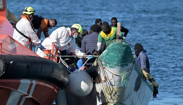 epa11963402 A boat (R) with 58 migrants on board is tugged by a Spanish Sea Rescue ship after its rescue, at the port of La Restinga, on El Hierro Island, Canary Islands, southwestern Spain, 14 March 2025. EPA/Gelmert Finol