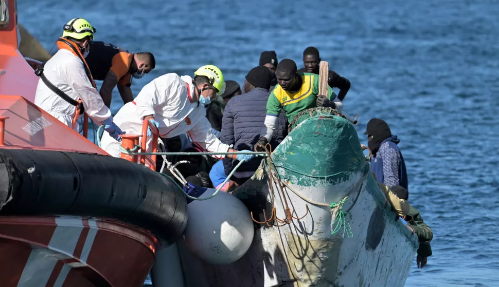 epa11963402 A boat (R) with 58 migrants on board is tugged by a Spanish Sea Rescue ship after its rescue, at the port of La Restinga, on El Hierro Island, Canary Islands, southwestern Spain, 14 March 2025. EPA/Gelmert Finol