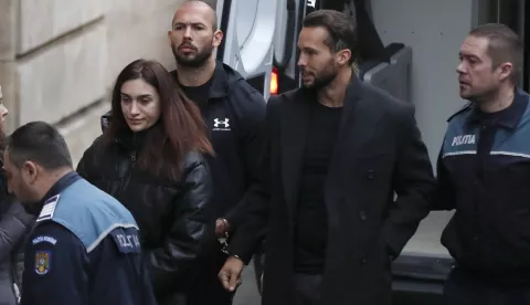 epa10397731 Former professional kickboxer and social media influencer, American-British businessman Andrew Tate (C), and his brother Tristan Tate are escorted by Romanian police officers inside the Court of Appeal building for a hearing in their trial in Bucharest, Romania, 10 January 2023. On 29 December 2022, Andrew and Tristan Tate were arrested as a result of Directorate for Investigating Organized Crime and Terrorism (DIICOT) division inquiry under the charges of human trafficking and the intention of forming an organized crime group. Romanian police stated that the two brothers and their associates coerced victims for creating a paid pornography service for social media platforms. A Romanian judge ordered on 30 December 2022 that Andrew Tate shall remain in police custody for 30 days, as criminal police investigation is ongoing. In total, 11 cars and ten buildings located near Bucharest, or in Ilfov and Prahova counties, owned by the Tate brothers, were seized by the Romanian authorities until the inquiry will be finished. EPA/Robert Ghement