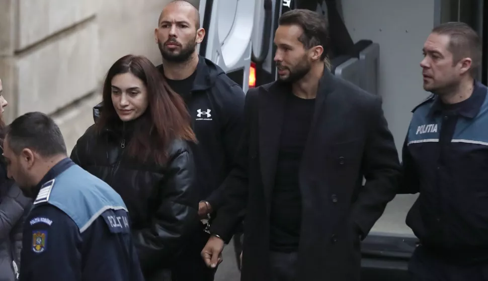 epa10397731 Former professional kickboxer and social media influencer, American-British businessman Andrew Tate (C), and his brother Tristan Tate are escorted by Romanian police officers inside the Court of Appeal building for a hearing in their trial in Bucharest, Romania, 10 January 2023. On 29 December 2022, Andrew and Tristan Tate were arrested as a result of Directorate for Investigating Organized Crime and Terrorism (DIICOT) division inquiry under the charges of human trafficking and the intention of forming an organized crime group. Romanian police stated that the two brothers and their associates coerced victims for creating a paid pornography service for social media platforms. A Romanian judge ordered on 30 December 2022 that Andrew Tate shall remain in police custody for 30 days, as criminal police investigation is ongoing. In total, 11 cars and ten buildings located near Bucharest, or in Ilfov and Prahova counties, owned by the Tate brothers, were seized by the Romanian authorities until the inquiry will be finished. EPA/Robert Ghement