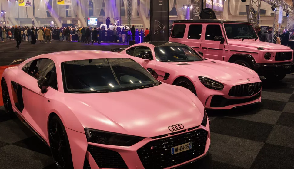 epa11085896 Pink Audi and Mercedes cars on display during a press day of the first edition of the Brussels Auto Show 2024 in the Expo in Brussels, Belgium, 17 January 2024. Already 80,000 tickets have been sold due to the great interest of the public in the new concept of Brussels Auto Show 2024. Over 100 companies present motorbikes, second-hand, chrome, hydrogen and solar cars. The Belgian Air Force displays an F-35 simulator and an F16 fighter jet. EPA/OLIVIER MATTHYS