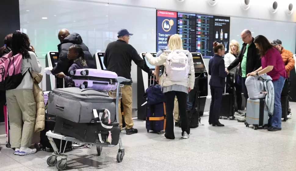 epa11980565 Passenger stand with luggage at a departure lounge in Heathrow Airport in Hounslow, Britain, 22 March 2025. Flights resumed at Heathrow Airport following a power outage on 21 March 2025. A fire at a substation which supplies power to Heathrow forced its closure for most of 21 March, leading to thousands of cancelled flights and stranding passengers across the world. Heathrow is Europe's busiest Airport and the Metropolitan Police's Counter Terrorism Command is leading the investigation into the cause of the fire at the electrical substation. EPA/NEIL HALL