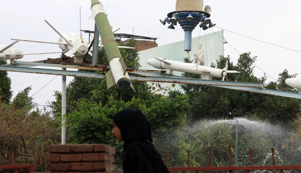 epa11972478 A woman passes by a display of Houthis-made mock missile and drones at a square in Sana'a, Yemen, 18 March 2025. Yemen's Houthis have claimed to have targeted the USS Harry S. Truman carrier group with cruise missiles and drones in the northern Red Sea in response to the US airstrikes against their positions in several cities across war-torn Yemen, Houthi military spokesman Yahya Sarea said in a statement. EPA/YAHYA ARHAB