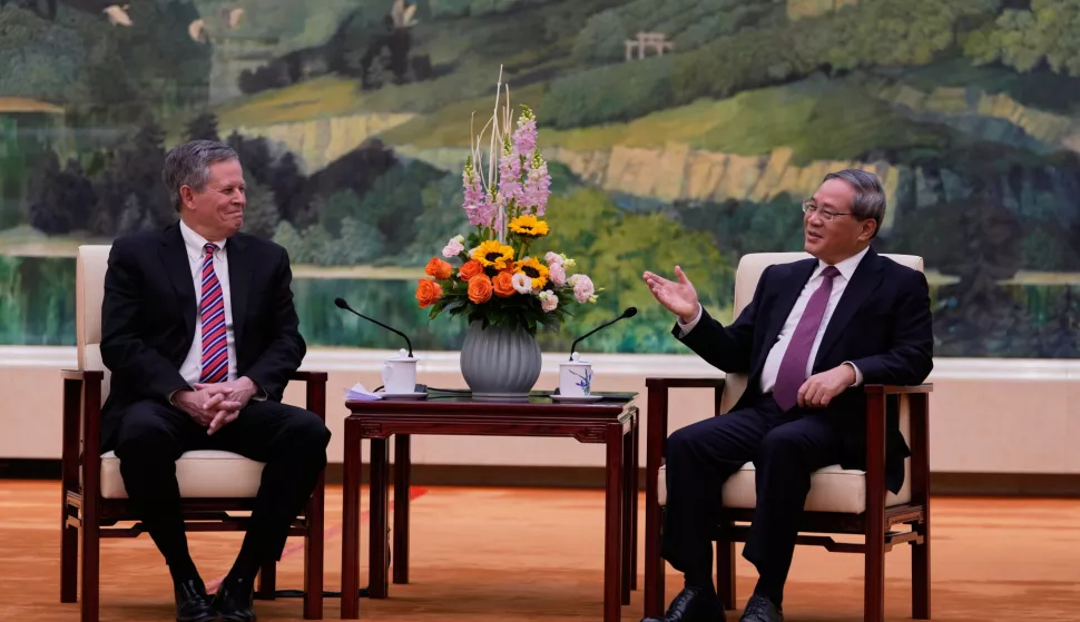 epa11982520 Chinese Premier Li Qiang (R) meets US Senator Steve Daines on the sidelines of the China Development Forum in Beijing, China, 23 March, 2025. EPA/Ng Han Guan/POOL
