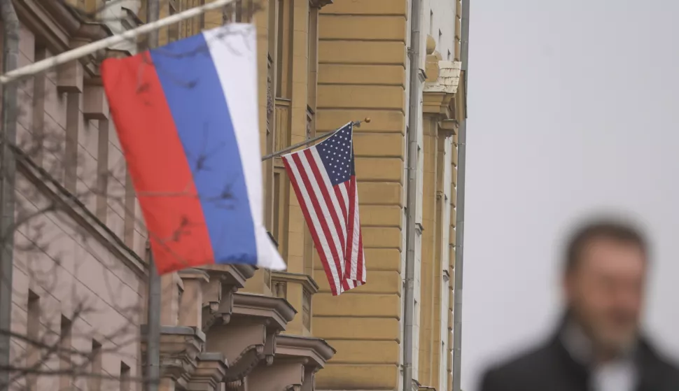 epa11958141 A man walks near Russian (front) and US flags hanging on the main building of the US Embassy in Moscow, Russia, 12 March 2025. The Kremlin expects the US to inform Russia about the results of the US-Ukrainian talks in Jeddah, and does not rule out a telephone conversation between Presidents Vladimir Putin and Donald Trump, said Dmitry Peskov, the press secretary of the head of the Russian state. As a result of the talks between the American and Ukrainian sides in Saudi Arabia, Kyiv agreed to a 30-day truce in the conflict in Ukraine. EPA/SERGEI ILNITSKY
