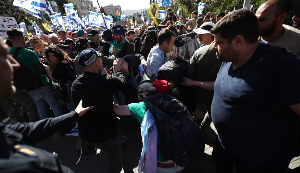 epa11973932 Police and demonstrators clash during a march to protest the resumption of fighting in Gaza and against Israeli Prime Minister Netanyahu's announced plans to dismiss Shin Bet chief Ronen Bar, in Jerusalem, 19 March 2025. EPA/ATEF SAFADI