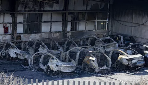 epa12001635 A view of burnt out vehicles at a vandalised Tesla car dealership where 17 parked cars were destroyed by fire overnight on the outskirts of Rome, Italy, 31 March 2025. Investigators have not excluded arson as they probe the causes of the overnight fire at the Tesla dealership. EPA/MASSIMO PERCOSSI