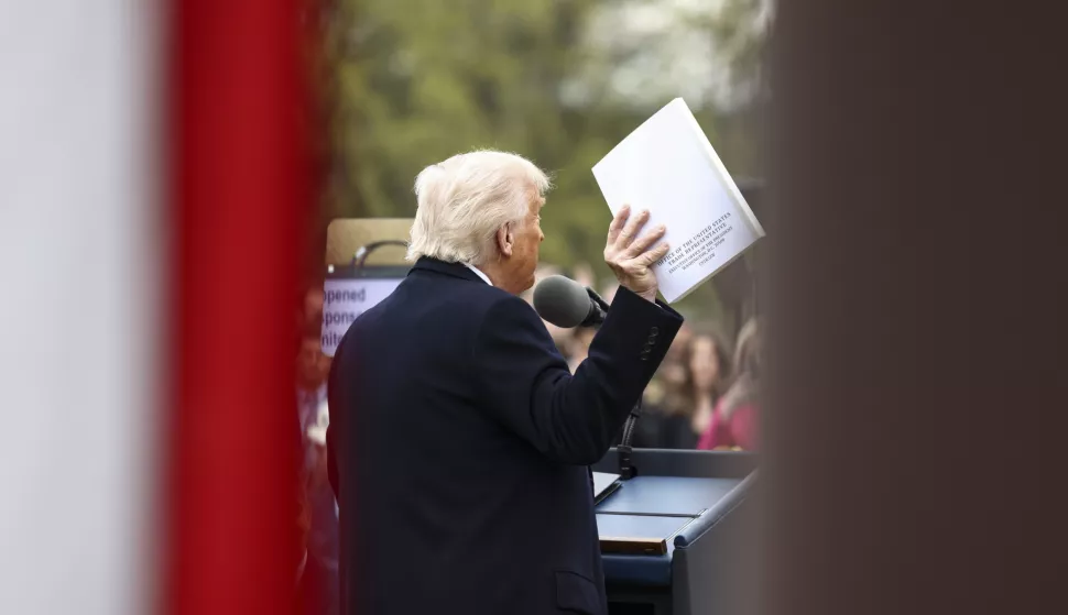 epa12006017 US President Donald Trump holds up a document from the Office of the United States Trade Representative as he announces reciprocal tariffs against US trading partners in the Rose Garden of the White House in Washington, DC, USA, 02 April 2025. Trump has branded the day 'Liberation Day', though most economists expect US consumers to foot the costs. EPA/JIM LO SCALZO/POOL