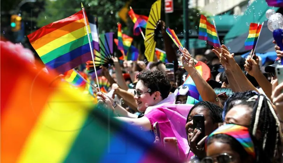 epa09306417 Spectators react and wave pride flags at the 52nd annual New York City Gay Pride Parade, in New York, New York, USA, 27 June 2021. The theme for NYC Pride 2021 is appropriately titled 'The Fight Continues', and it refers to several national and local concerns, including police brutality, state anti-LGBT legislation, and economic hardship. EPA/Peter Foley