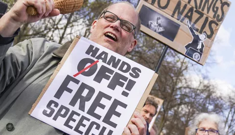 epa12011821 Participants hold placards during a protest in front of the US Embassy in Berlin, Germany, 05 April 2025. The rally organized by Democrats Abroad, the official organization of the Democratic Party for US citizens living abroad, say the protest was "in defense of democracy" and against actions taken by the US President Donald Trump and senior advisor to the US president Elon Musk. EPA/ELLEN KALLSCHEUER
