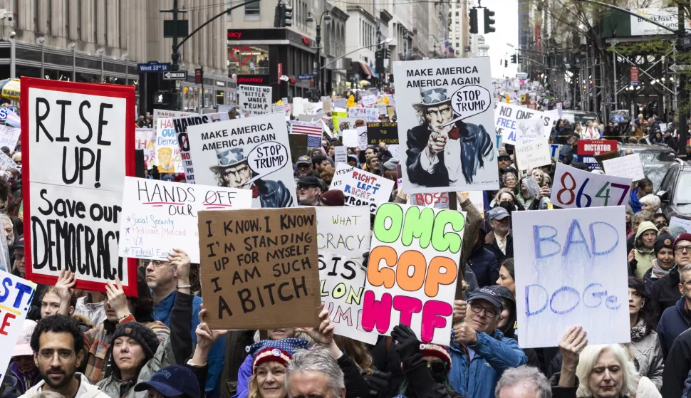 epa12012128 People march down Fifth Avenue during a protest against US President Donald Trump and his administration's policies, in New York, New York, USA, 05 April 2025. Several protests are scheduled to take place across the country against the US president on 05 April. EPA/JUSTIN LANE
