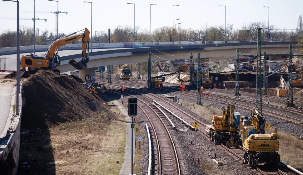 epa12009434 An excavator dredges material on the A100 city highway bridge in Berlin, Germany, 04 April 2025. As the senate of Berlin informed in a press release, the demolition of the depilated Ringbahn bridge is about to begin next week. The dismantling of both bridges should be largely completed by 25 April 2025. According to the current status, the interrupted S-Bahn train service will resume on 28 April 2025. EPA/CLEMENS BILAN